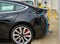 Tarragona, Spain. February 22: Charging port of a black electric luxury Tesla Model S car plugged in a charging station