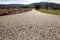 Tarred road in landscape with backlight