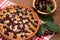 Tart cherry in the form of a wooden table covered with a checker