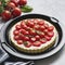 Tart with cherry tomatoes, cheese and onions on aluminum baking dish. From series Healthy Eating