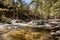 Tartagine river flows over colourful pebbles in Corsica