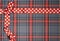 Tartan background texture with polka dots and red ribbon