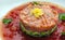 Tartar beefsteak with fresh cucumbers and tomato sauce