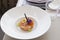 The Tartar from salmon with red caviar decorated with violet flowers and caramelized decoration