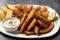 tartar sauce. Fried potatoes with seafood and tartar sauce, close-up. Generative AI