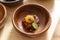 Tartare of beef on a wooden plate with egg yolk.
