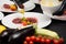 Tartare meat with egg, cucumber, tomato and avocado closeup on a white plate