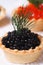 Tartlet with black sturgeon caviar and dill macro