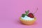 Tartlet with cream and ripe strawberries on a pink background