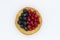 Tartlet with red and black currant white background