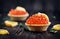 Tartlet with salmon caviar closeup. Snacks with trout caviar