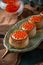 Tartlets or canapes with butter and red caviar. Gourmet food, appetizer. Delicatessen.