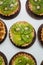 Tartlets with caramel and nuts. Delicious appetizing tarts with kiwi on a white background