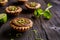 Tartlets with chocolate, pistachios and lime peel