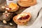 Tartlets with cream, berry sauce and pistachios