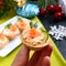 Tartlets with cream cheese and red salted salmon on a white plate for the festive table. Tasty portion light snack for a party.