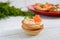 Tartlets with cream cheese and salted salm on a white wooden background. Tasty light snack for a party.