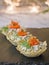 Tartlets with cream cheese and smoked salmon on black slate. Festive New Year`s dish. Christmas snack. Close up, copy space,