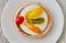 Tartlets with cream and fruits, orange, kiwi, cherry