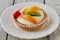 Tartlets with cream and fruits, orange, kiwi, cherry