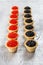 Tartlets filled with red and black caviar against rustic wooden background