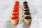 Tartlets filled with red and black caviar against rustic wooden background