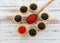 Tartlets filled with red and black caviar against rustic wooden background