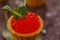 Tartlets with red caviar. Holiday concept. Still life with greenery decor. Close-up