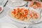 tartlets with red fish eggs, shrimp and butter on the festive table