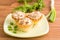 Tartlets with salad on a saucer and fresh herbs