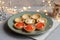 Tartlets with soft cheese, shrimp and red caviar. Holiday dish. On a green plate