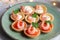 Tartlets with soft cheese, shrimp and red caviar. Holiday dish. On a green plate