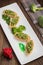 Tartlets stuffed with minced meat broccoli and tuna. Wooden background