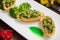 Tartlets stuffed with minced meat broccoli and tuna. Wooden background