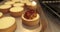 Tartlets on the table of a professional confectioner are decorated with apple-jelly