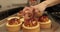 Tartlets on the table of a professional confectioner are decorated with apple-jelly