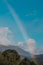 Tasmanian landscape with green hills and mountains with rainbow