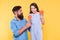 Taste the rainbow. Family of father and daughter eat candies. Happy family yellow background. Bearded man entertain