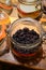 Tastes of gin, botanicals ingredients for gin distillery process, pot with dried mulberries