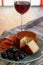Tastes of Spain, jamon iberian, black olives, manchego cheese with red paprika and glass with red rioja wine