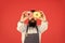 Tastiest selection of doughnuts around. Baker with glazed doughnuts. Bearded man holding ring doughnuts on red