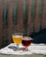 Tasting of Belgian beer on open cafe or bistro terrace with view on medieval houses and canals in Bruges, Belgium