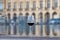 Tasting of Bordeaux blended red wine with wine city Bordeaux on background, left bank of Gironde Estuary, France. Glass of red