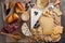 Tasting cheese dish on a wooden plate. Food for wine and romantic, cheese delicatessen on a wooden rustic table. Top view with cop