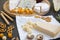 Tasting cheese plate with fruits, pretzels, walnuts and bread sticks on dark background.