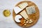 Tasting cheese with wine, walnuts and pretzels on wooden background. Food for romantic. From above. Top view.