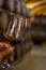 Tasting of fortified dry or sweet marsala wine in vintage wine cellar with old oak barrels in Marsala, Sicily, Italy