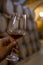 Tasting of fortified dry or sweet marsala wine in vintage wine cellar with old oak barrels in Marsala, Sicily, Italy