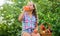 Tasting juice. harvest vitamin. spring market garden. little girl vegetable in basket. Only natural. healthy food for