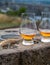 Tasting of single malt scotch whisky in glasses with view from Calton hill to new and old parts of Edinburgh city in rainy day,
